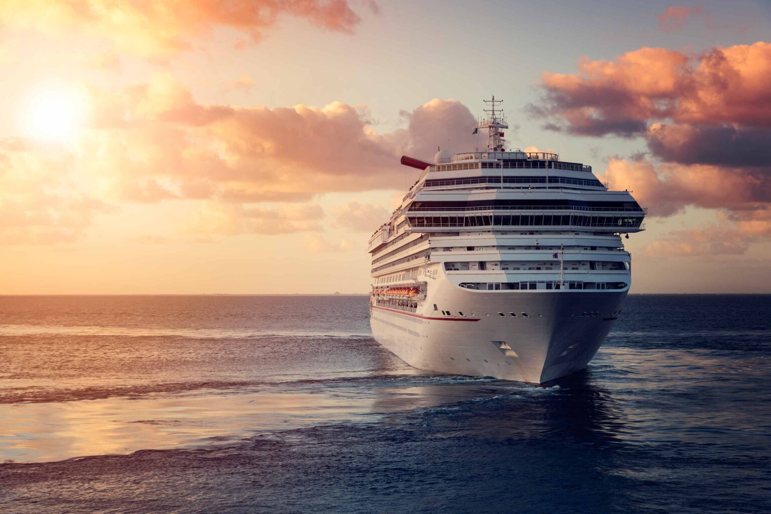 Modern cruise ship sailing at sunset, symbolizing Colombo Fasteners' high-performance fasteners designed for naval applications, ensuring durability and reliability in marine environments.